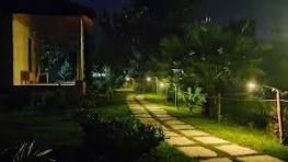 Lantern-lit garden path at Sampada Village after dark